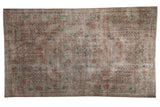 Vintage distressed Oushak carpet in overdyed silver with a rose bouquet border and a central medallion.