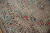 Close-up on the low pile and hand-knotted texture of the vintage Oushak's floral border.