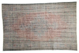 Distressed Overdyed Oushak carpet with faded medallion pattern in dusty blue, mauve, and red.