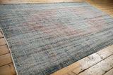 Decorative distressed texture of the Oushak carpet with dusty royal blue and pale brick red tones.