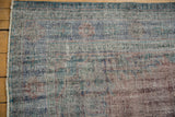 Distressed Oushak carpet pile with wear to foundation, showcasing dusty blue and mauve tones.