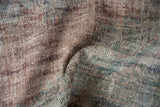Distressed texture of vintage overdyed Oushak carpet with visible knot heads and muted colors.