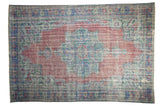 Distressed Oushak carpet featuring faded raspberry field, pale royal blue, and sea foam green medallion.