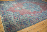 Distressed vintage Oushak rug corner, dusty raspberry field, pale royal blue motifs, and textured wear.
