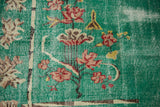 Pale turquoise distressed Turkish Art Deco carpet, detailed lotus flowers and worn texture.