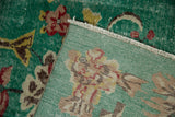 Distressed green floral pile and hand-knotted reverse of a vintage Turkish carpet.