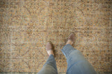 Distressed vintage Sparta carpet with allover scrolling vinery, dusty gold, mauve, and green hues.
