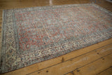 Detail of distressed terracotta field, floral palmettes, and ivory cartouche border of the Turkish Sparta rug.