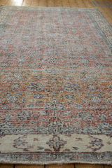 Distressed pile texture of vintage Sparta rug with terracotta, ivory, and blue vinery.