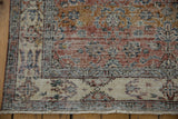 Distressed corner of Turkish Sparta rug, terracotta, ivory floral, visible knot heads and fringe.