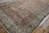 Vintage distressed Turkish Sparta rug, apricot scrolling vinery, ivory floral border, and aged texture.