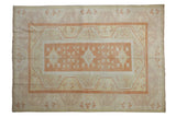 Distressed Oushak rug with pale burnt orange rectangular medallion, ivory and yellow patterns. 5'3