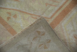Vintage distressed Oushak rug: pale orange pile, tight foundation, intact selvage, and fringe.