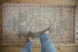 Faded, distressed Oushak rug with soft pale terracotta, silver, and tangerine colors.