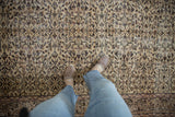Close-up of the traditional vintage distressed Sparta carpet's scrolling vinery and soft, even wear.