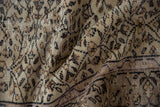 Textured fold of vintage distressed Sparta rug with scrolling vinery, worn knot heads, beige and brown.