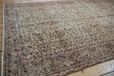 Distressed vintage Sparta rug's scrolling vinery, subtle lilac, and visible knot heads.