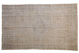 Distressed Oushak carpet featuring faded ivory, beige, and pale blue medallion. 5'8