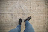 Distressed vintage Oushak rug texture, worn to foundation, in ivory and pale blue.