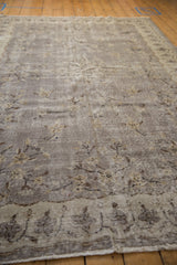 Distressed vintage Sparta carpet pile with subtle floral bouquets in softened silver and charcoal.