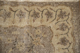 Distressed hand-knotted floral pattern of a vintage Sparta rug in silver and ivory.