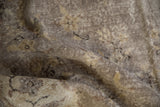 Distressed vintage Sparta rug pile showing textured oxidized silver and charcoal tones.