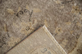 Vintage Sparta carpet's distressed silver and ivory pile, visible foundation, and fringe.