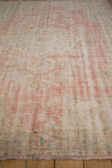 Distressed Oushak rug pile in pale rose, ivory, showing even wear to knot heads.