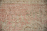 Softly faded pale rose, ivory, and seafoam green pile texture of vintage distressed Oushak.