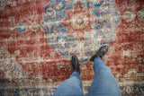 Worn cherry red, sky blue, ivory Sivas carpet with visible knot heads and arabesque patterns.