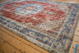 Vintage Sivas carpet's distressed cherry red and sky blue field with scrolling arabesques.