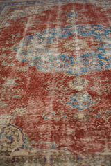 Distressed Sivas carpet pile, showing worn texture in cherry red and sky blue.