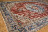 Distressed cherry red field and sky blue arabesque border on a vintage Sivas rug.