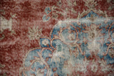 Distressed Sivas carpet texture featuring cherry red and sky blue arabesques.