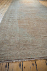 Low perspective view of a distressed Oushak runner, showcasing its muted, even-worn texture.