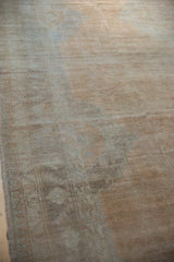 Close view of the distressed Oushak runner's pile with even wear and soft sandalwood tones.