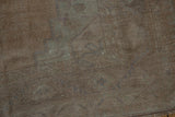 A close-up view of the even wear across the knot heads of the distressed vintage Oushak rug.