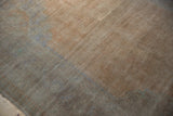 Evenly worn low pile of a vintage Turkish rug in soft sandalwood and silver hues.