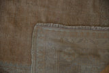 The hand-knotted construction visible on the back of the vintage distressed Oushak rug.