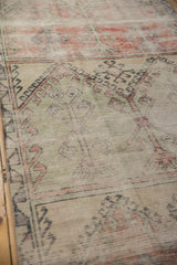 Distressed Oushak runner detail, showing worn germinating plant motifs in soft brick and mint.