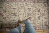 Distressed vintage Sparta runner detail: worn knot heads, visible foundation, muted floral palmettes.