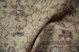 Vintage distressed Sparta rug pile with ivory, red, and navy floral motifs, revealing knot head wear.