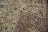 Distressed floral pile in ivory, brick red, navy, and hand knotted Sparta rug foundation.