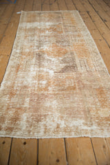 Distressed vintage Oushak runner, showing textured pile, exposed foundation, and secured side selvage.