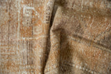 Textured pile of the distressed vintage Oushak rug in sandalwood, ivory, and beige.