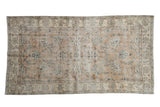 Hand-knotted distressed Sparta runner with faded sand, ivory, and muted blue floral palmettes.