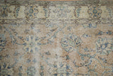 Distressed Sparta rug, floral palmettes with dusty navy and seafoam green, showing wear.