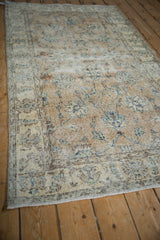Distressed Sparta runner, revealing worn pile, sand hues, and faded floral palmettes.