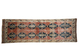Distressed Sparta runner rug with unique navy medallions on an abrashed red field.