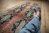 Distressed hand-knotted vintage Sparta runner with abrashed red field and navy curvilinear pattern.